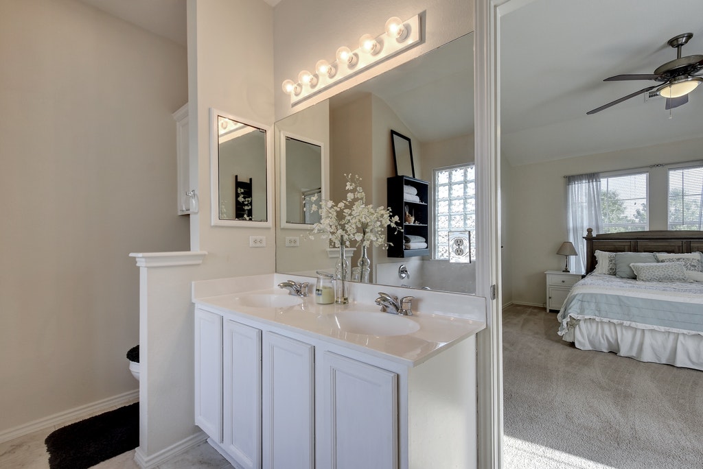 2201 Keepsake Drive Austin, TX 78745 - Photo 14 of 25 a en suite bathroom with double sink and a mirror