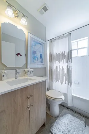 a bathroom with a sink toilet and shower