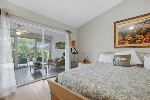 a bedroom with a large bed and a large window