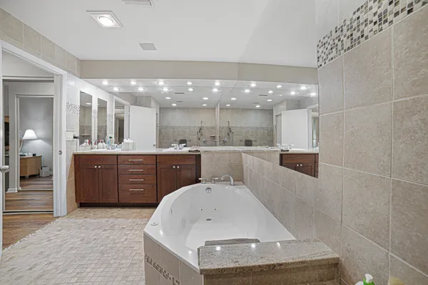 a large white kitchen with a sink and cabinets