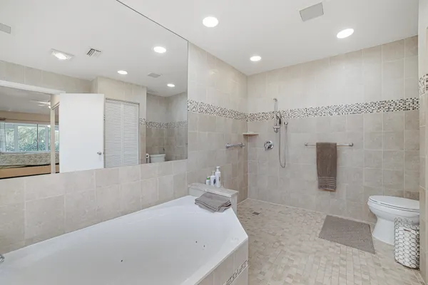 a bathroom with a tub a toilet and a sink