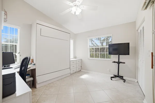 a view of a workspace with furniture and a window