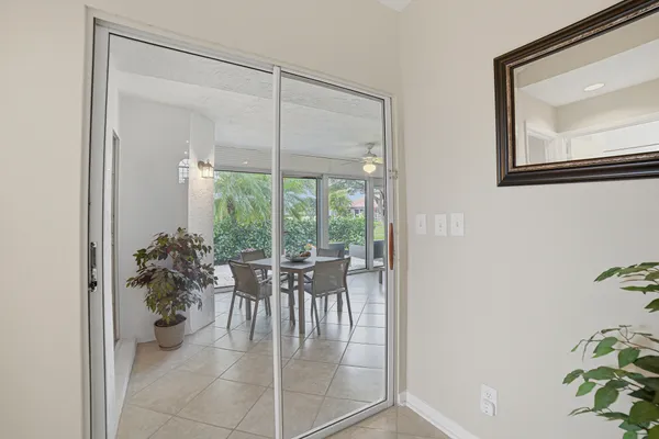 a dining room with furniture and a potted plant
