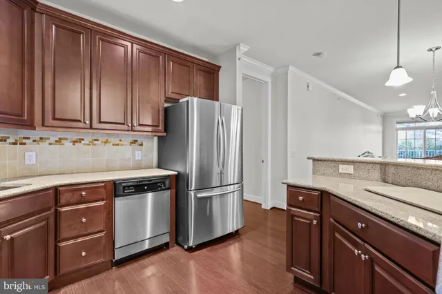 a kitchen with wooden cabinets and stainless steel appliances