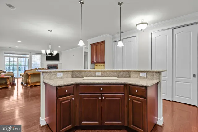 a kitchen with a sink a counter space appliances and a center island
