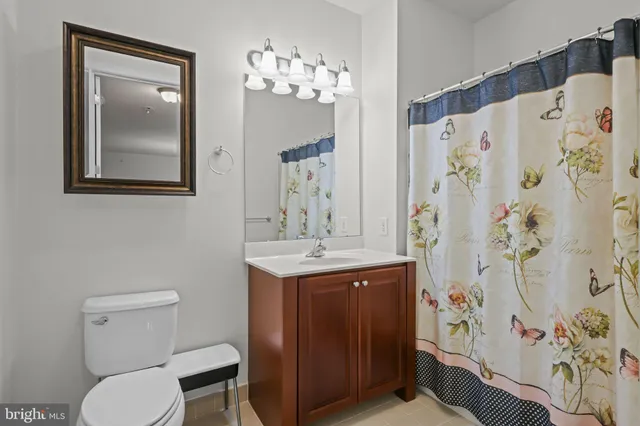 a bathroom with a toilet a sink and a mirror