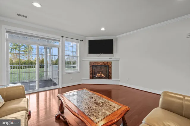 a living room with furniture rug and a flat screen tv