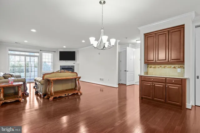 a living room with furniture flat screen tv and wooden floor