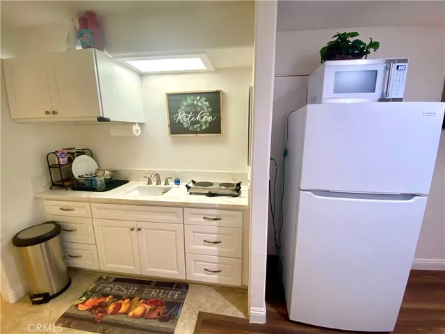 a kitchen with a refrigerator and cabinets