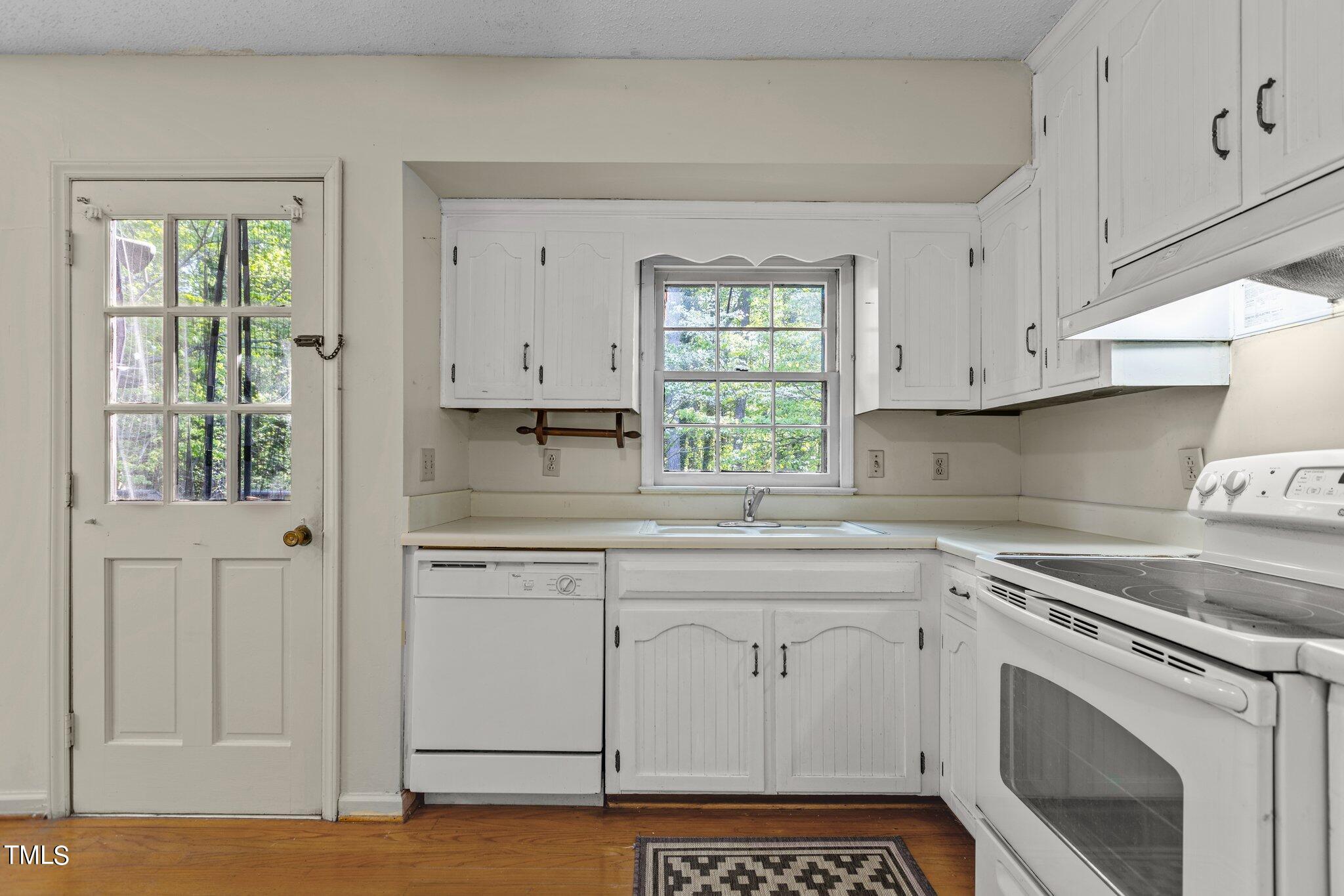 1500 Princess Anne Road Raleigh, NC 27607 - Photo 11 of 37 a kitchen with stainless steel appliances white cabinets and a window