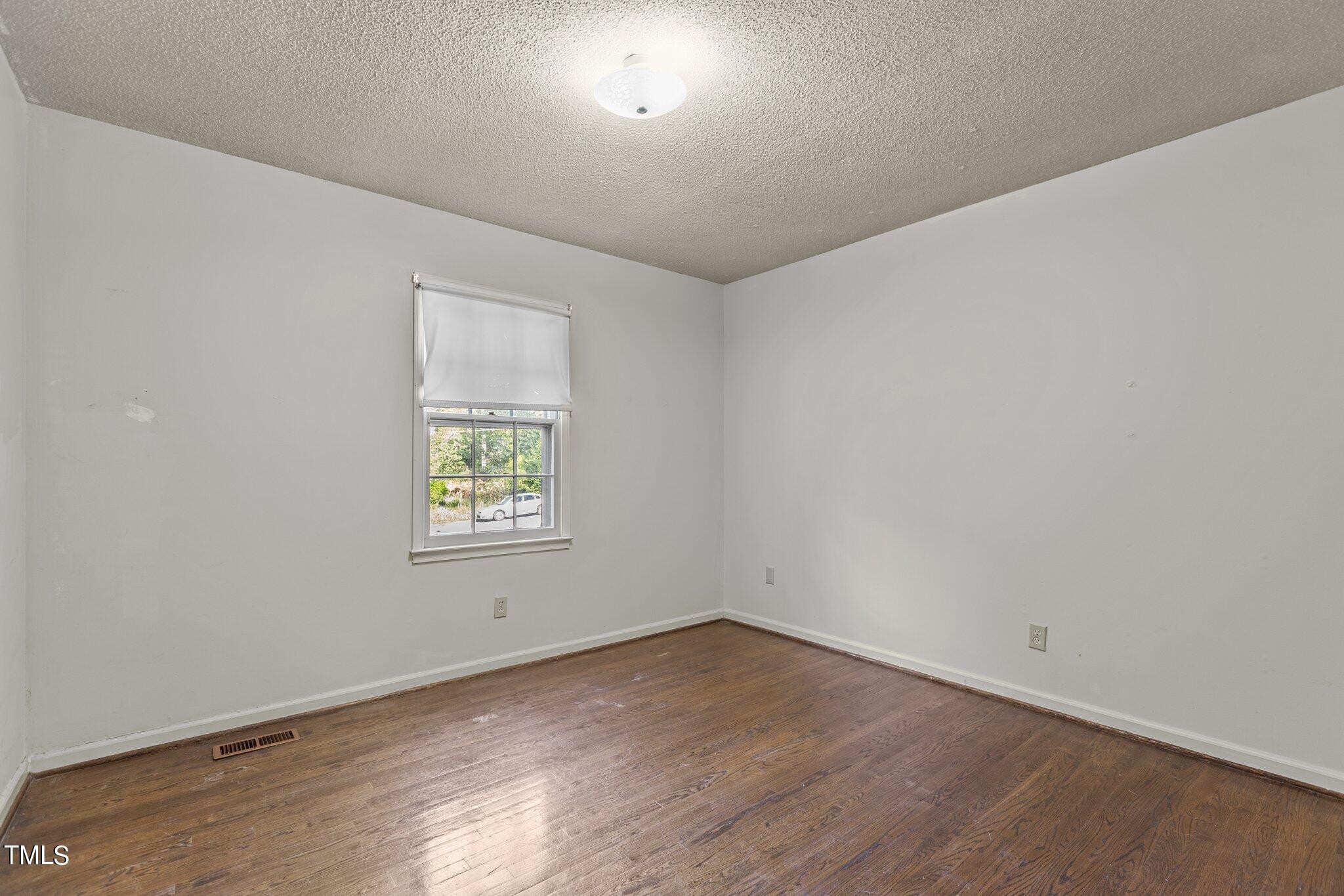 1500 Princess Anne Road Raleigh, NC 27607 - Photo 14 of 37 an empty room with wooden floor and window