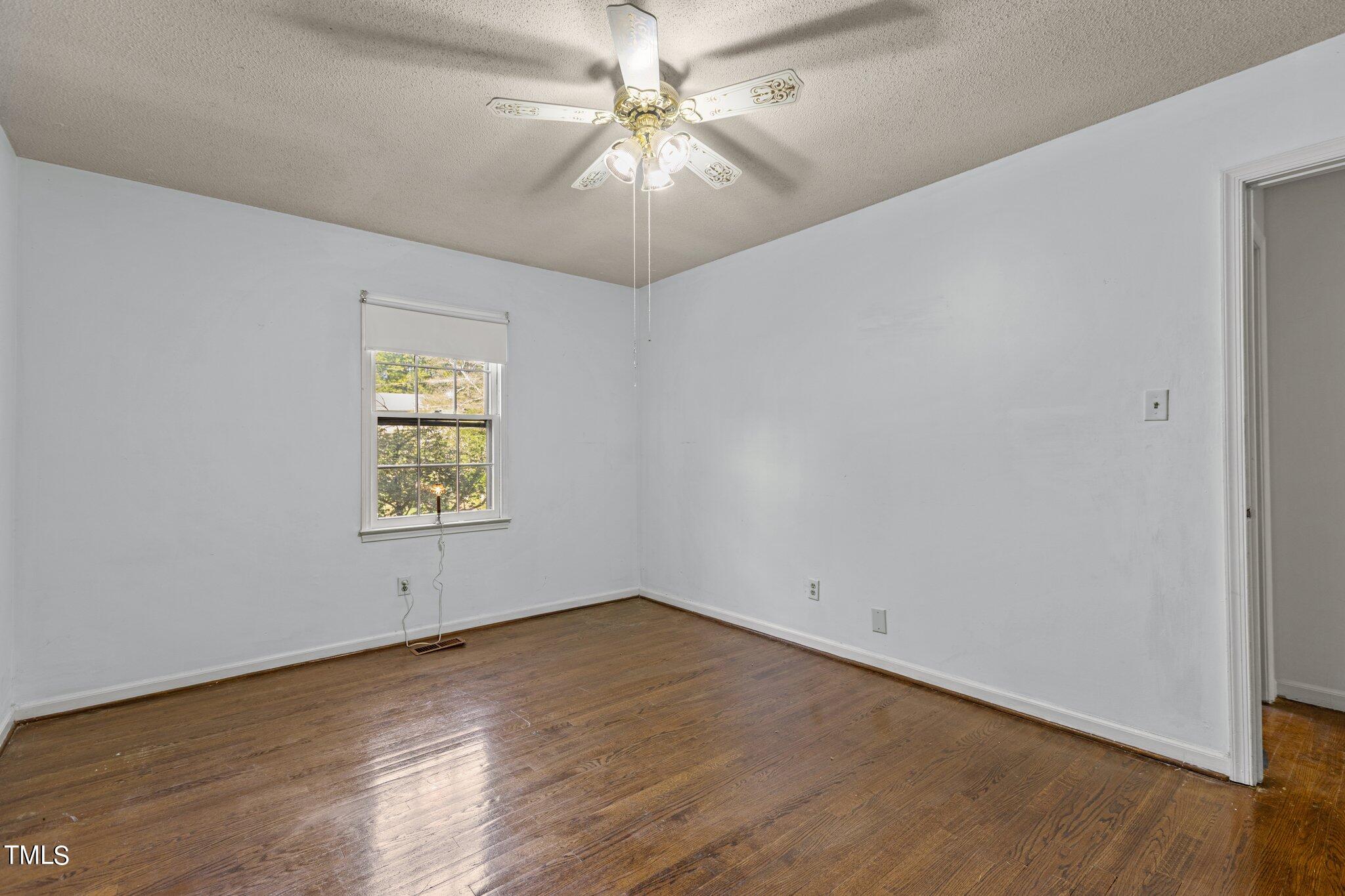 1500 Princess Anne Road Raleigh, NC 27607 - Photo 16 of 37 an empty room with a chandelier fan and windows