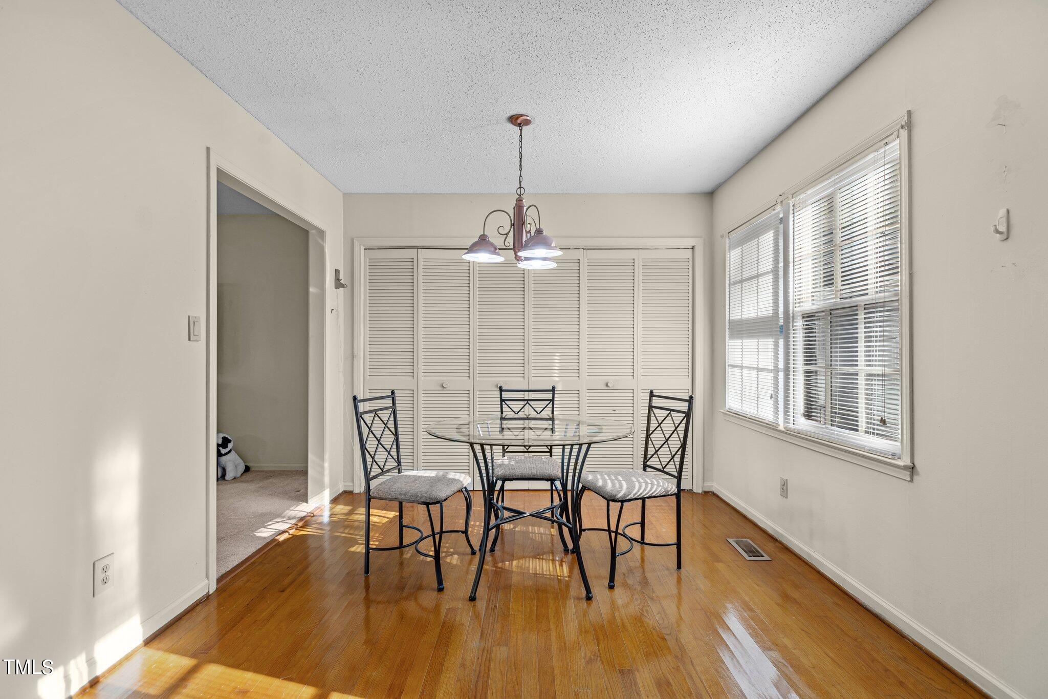 1500 Princess Anne Road Raleigh, NC 27607 - Photo 8 of 37 a view of a dining room with furniture window and wooden floor