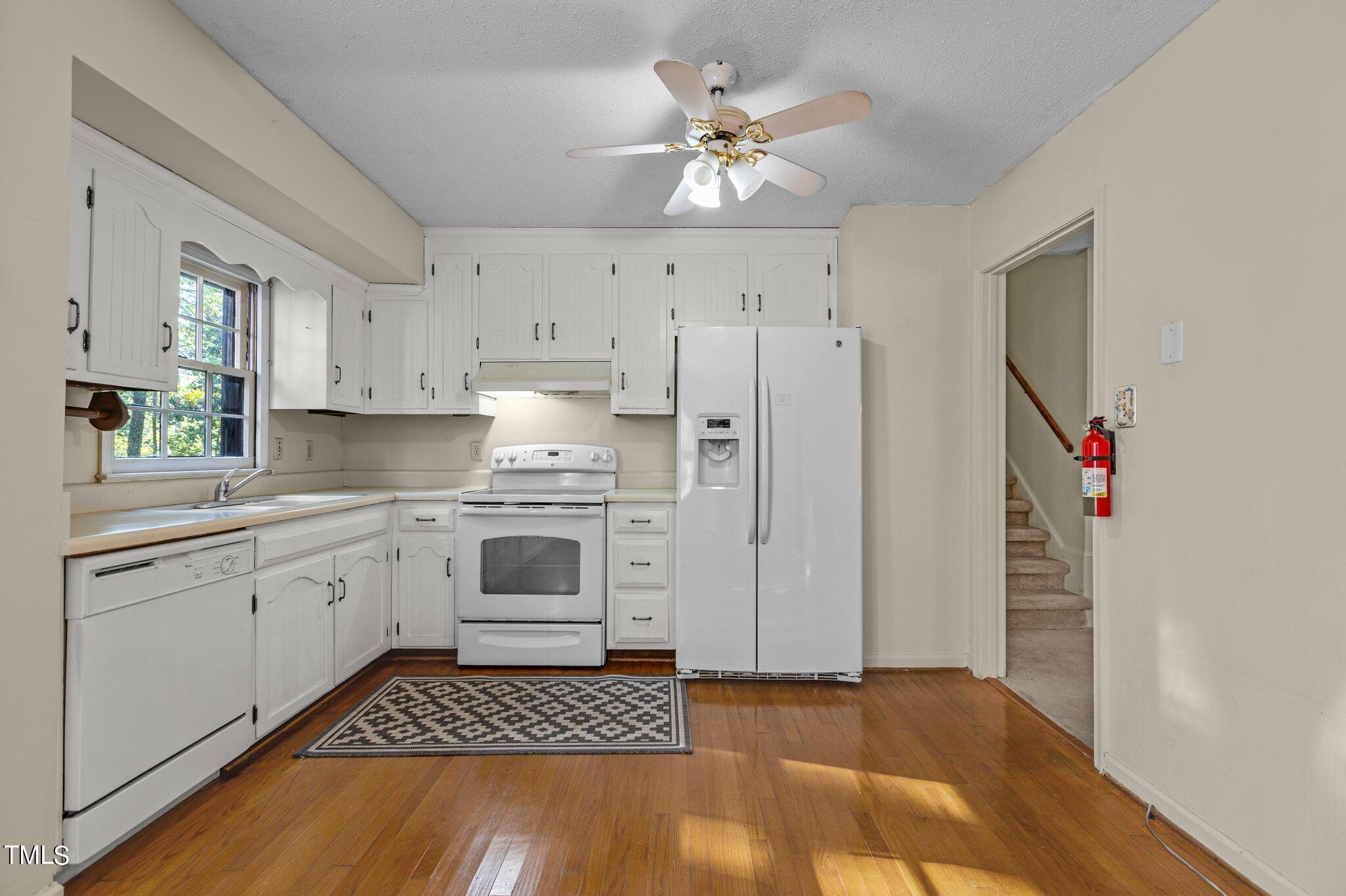 1500 Princess Anne Road Raleigh, NC 27607 - Photo 10 of 37 a kitchen with granite countertop a stove a sink and a refrigerator