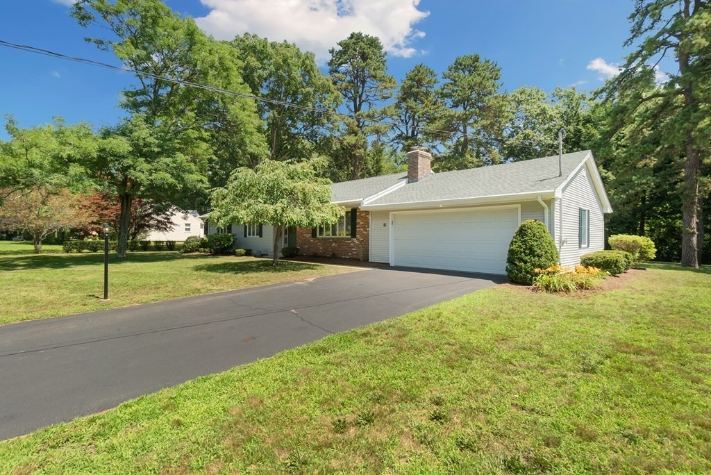 83 Redfern Drive Longmeadow, MA 01106 - Photo 3 of 40 a front view of a house with a yard and garage