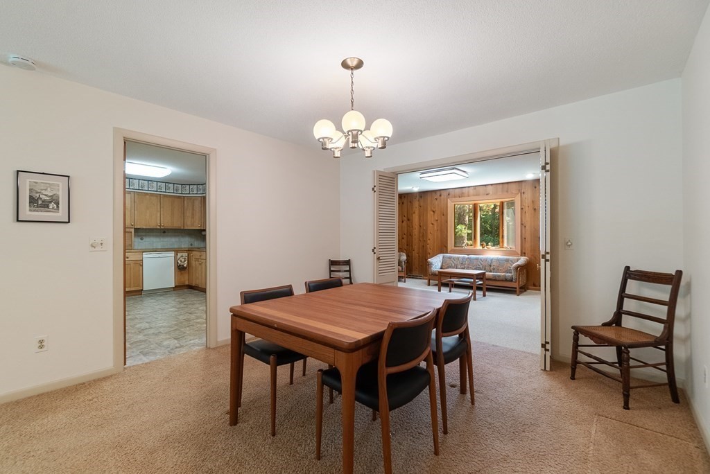 83 Redfern Drive Longmeadow, MA 01106 - Photo 8 of 40 a view of a dining room with furniture and a chandelier