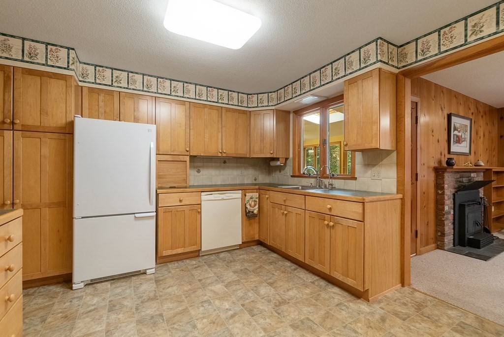 83 Redfern Drive Longmeadow, MA 01106 - Photo 9 of 40 a kitchen with granite countertop a refrigerator a sink and dishwasher