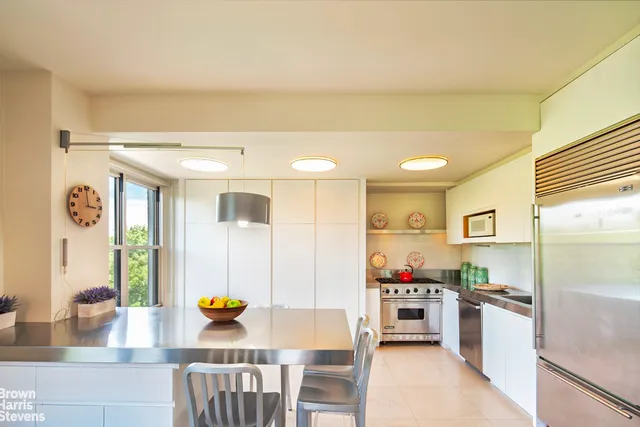 a kitchen with stainless steel appliances granite countertop a stove and a refrigerator