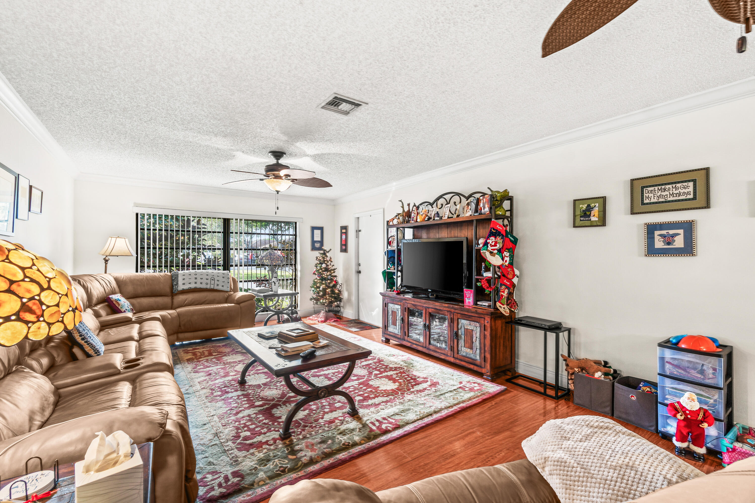 4863 Hawkwood Road, Unit B Boynton Beach, FL 33436 - Photo 11 of 23 a living room with furniture and a flat screen tv