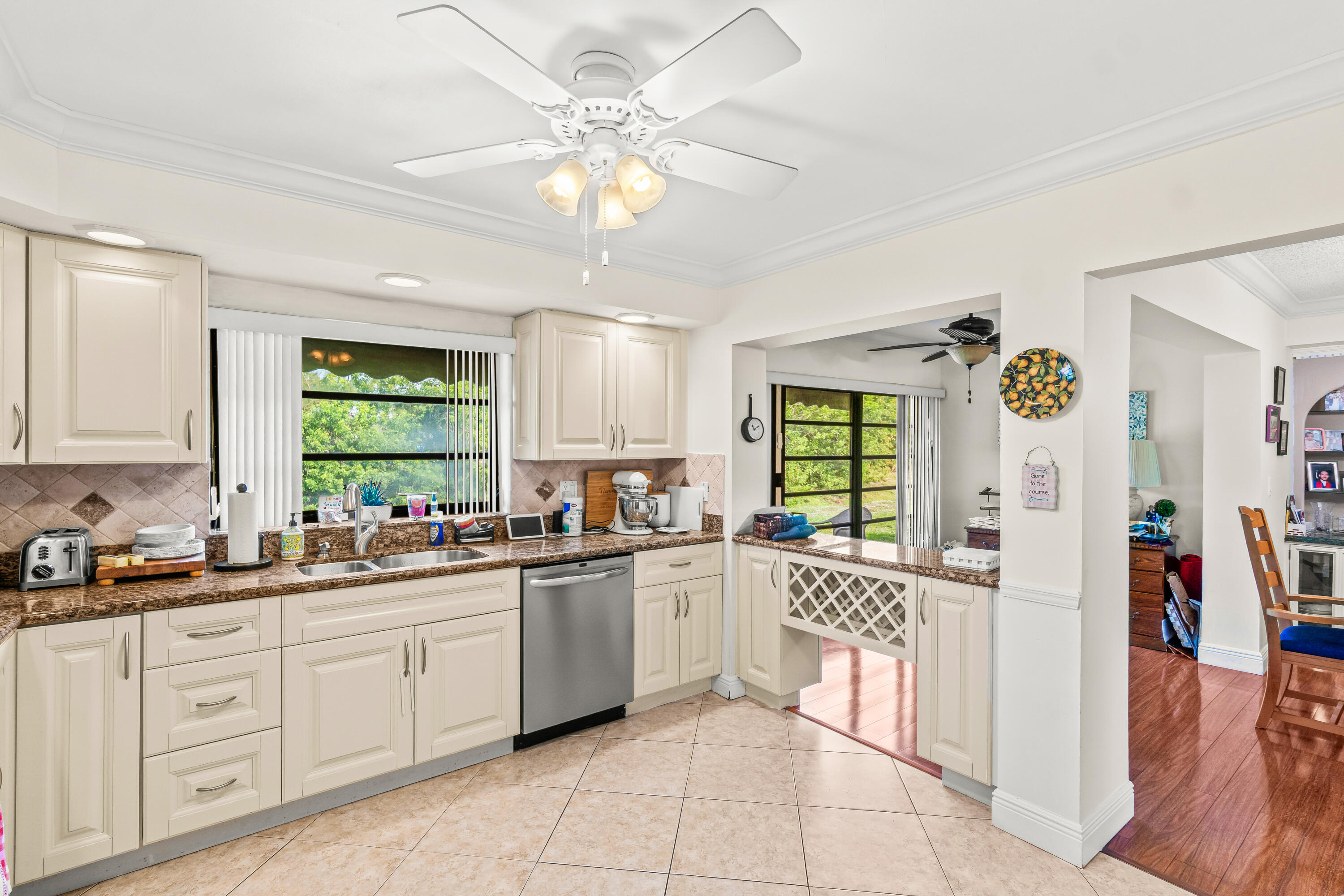 4863 Hawkwood Road, Unit B Boynton Beach, FL 33436 - Photo 4 of 23 a kitchen with a sink window and cabinets