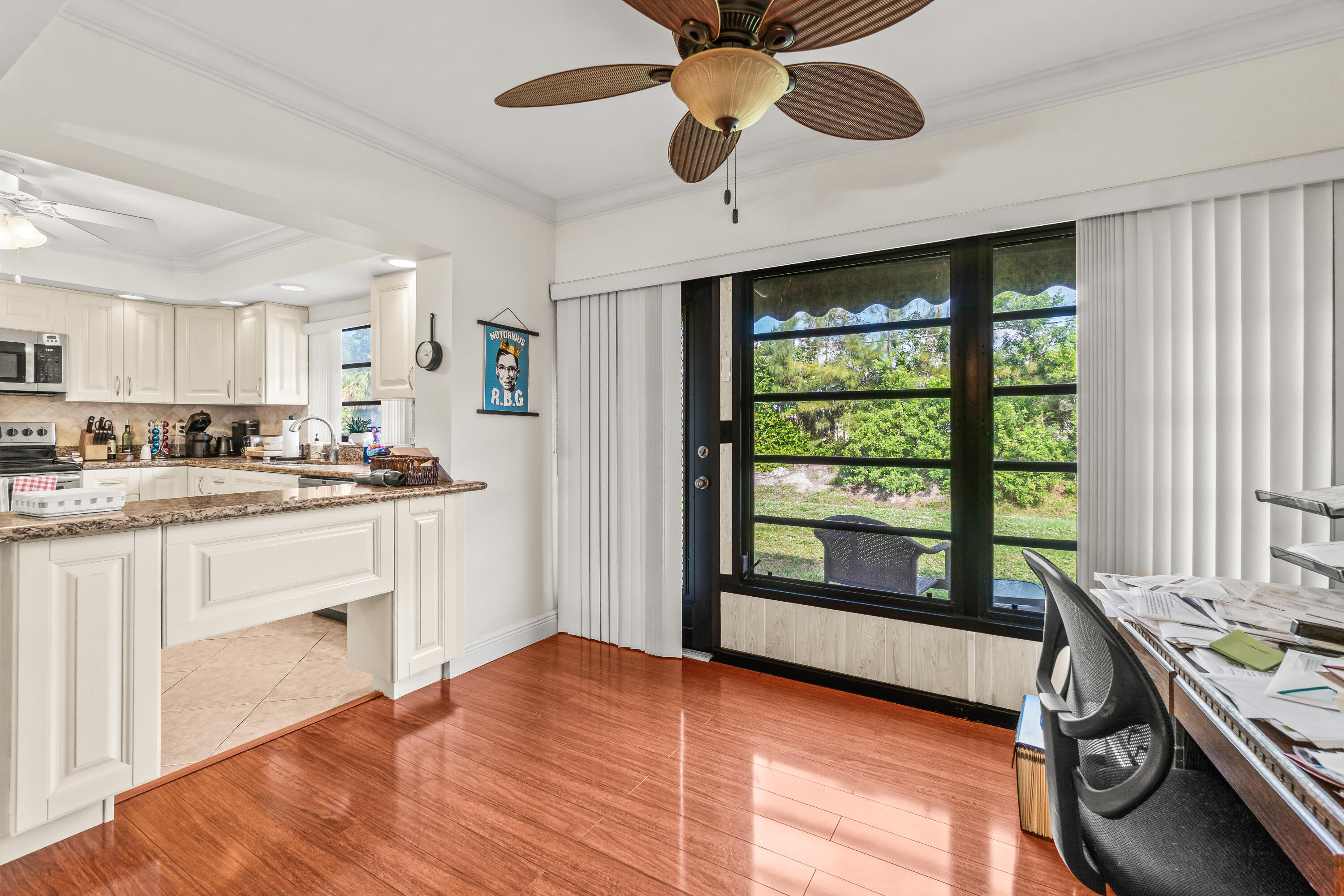 4863 Hawkwood Road, Unit B Boynton Beach, FL 33436 - Photo 6 of 23 a open kitchen with granite countertop a stove cabinets and wooden floor