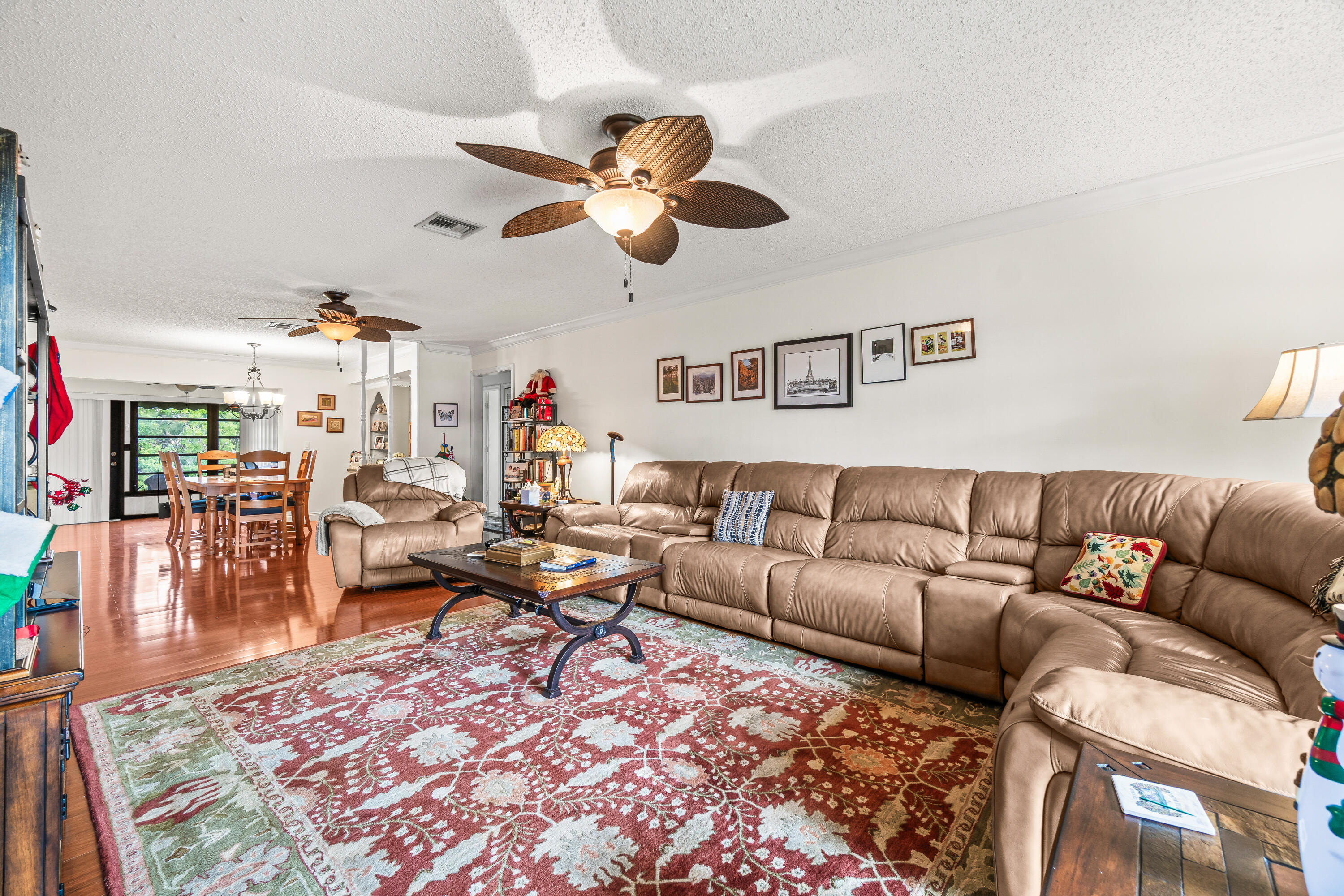 4863 Hawkwood Road, Unit B Boynton Beach, FL 33436 - Photo 10 of 23 a living room with furniture a rug and a chandelier