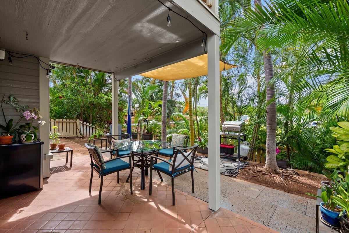 a view of an outdoor dining space with furniture and garden view
