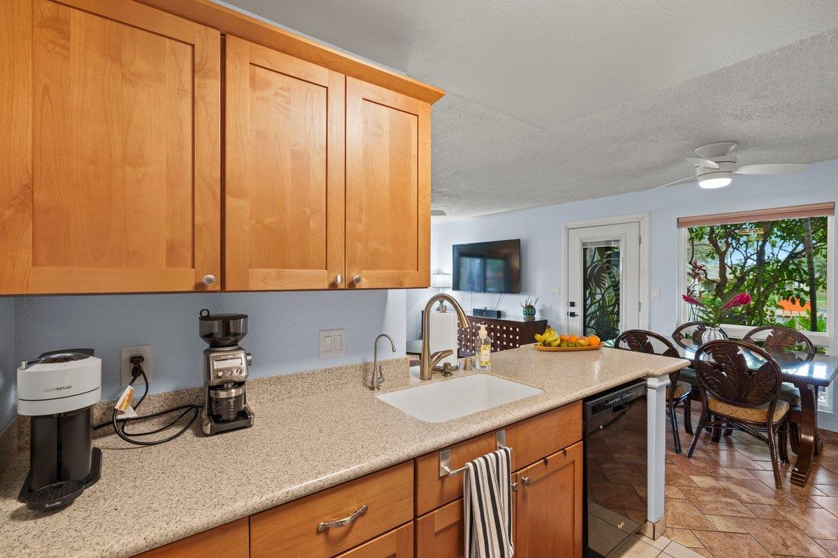 140 Uwapo Road, Unit 35102 Kihei, HI 96753 - Photo 19 of 30 a kitchen with a sink and cabinets