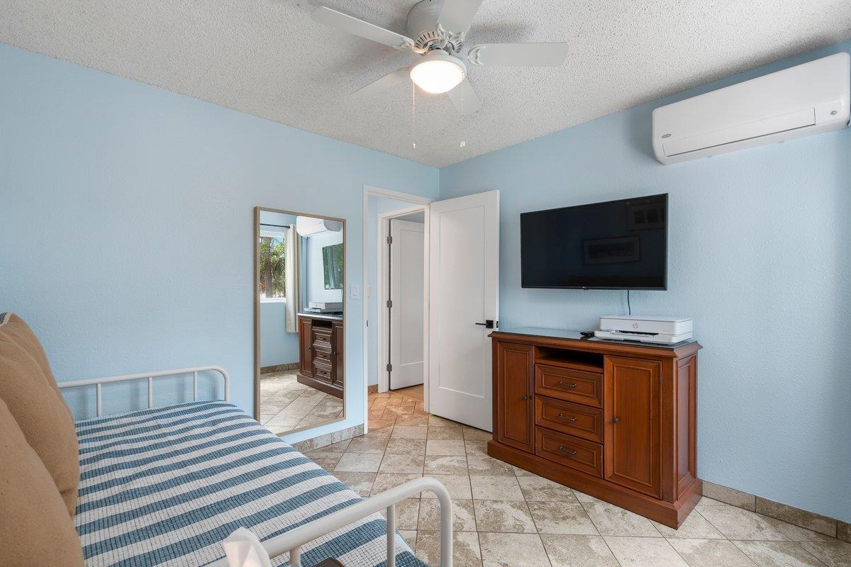 140 Uwapo Road, Unit 35102 Kihei, HI 96753 - Photo 21 of 30 a living room with furniture and a flat screen tv
