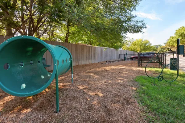 a backyard of a house with barbeque oven table and chairs