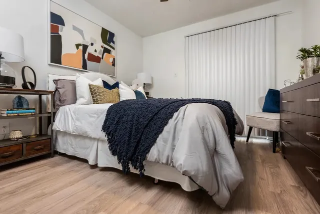 a spacious bedroom with a bed and a couch