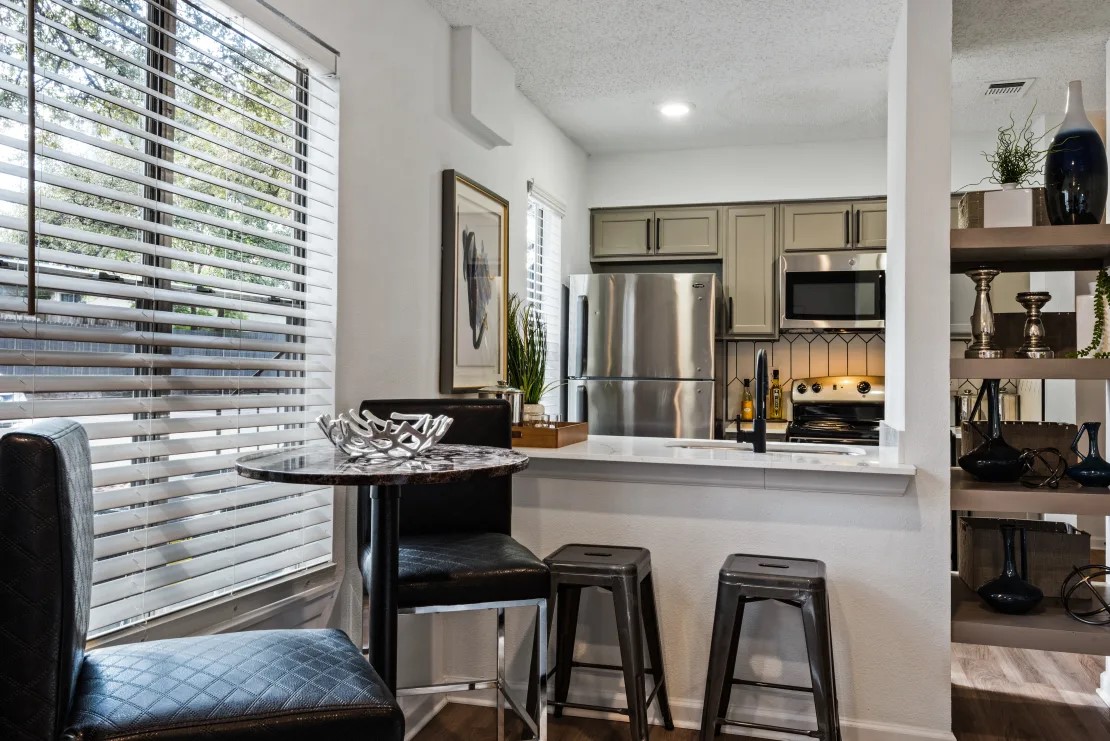 12001 Metric Boulevard, Unit 816 Austin, TX 78758 - Photo 7 of 21 a kitchen with stainless steel appliances granite countertop a sink and cabinets