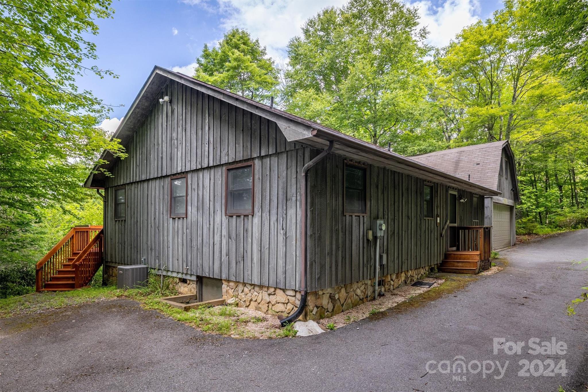 455 Hemlock Hill Road Boone, NC 28607 - Photo 2 of 37 a backyard of a house with wooden fence and a large tree