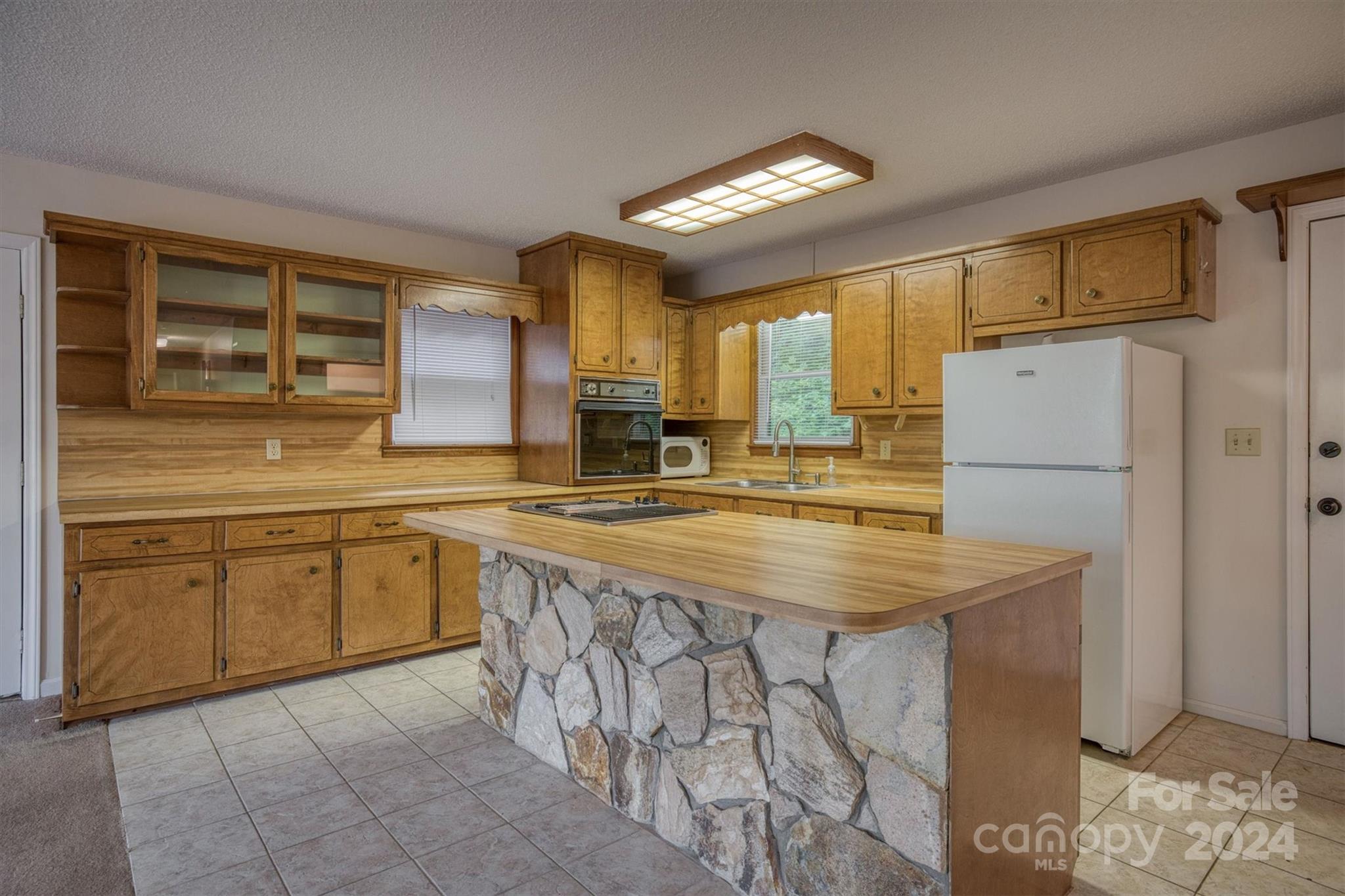 455 Hemlock Hill Road Boone, NC 28607 - Photo 24 of 37 a kitchen with stainless steel appliances granite countertop a sink stove and refrigerator