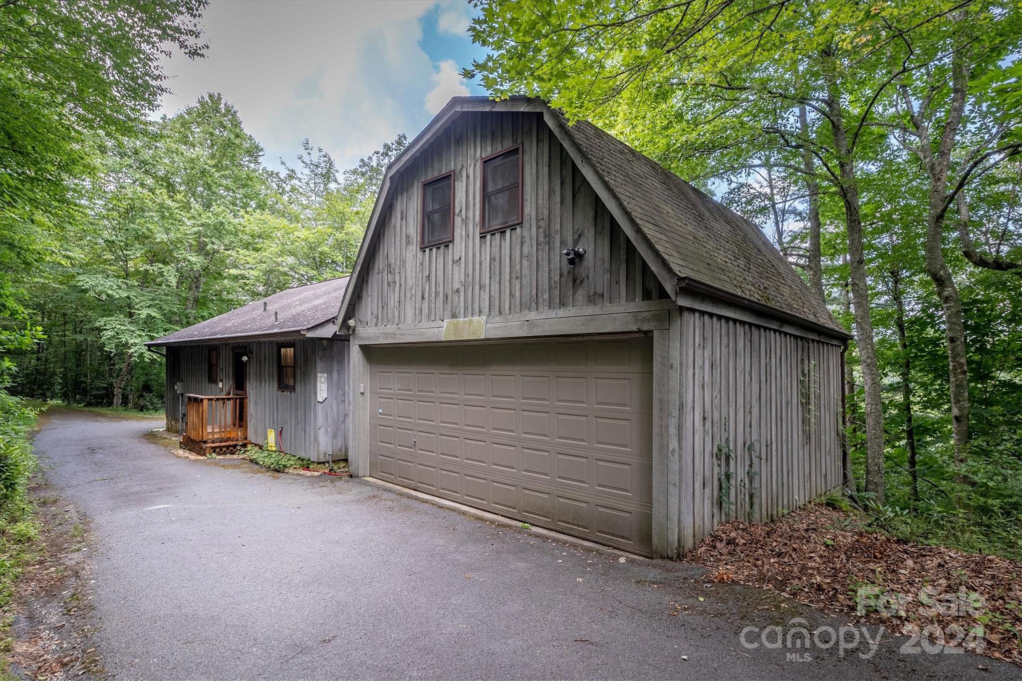 455 Hemlock Hill Road Boone, NC 28607 - Photo 3 of 37 a view of a house with a yard plants and large tree