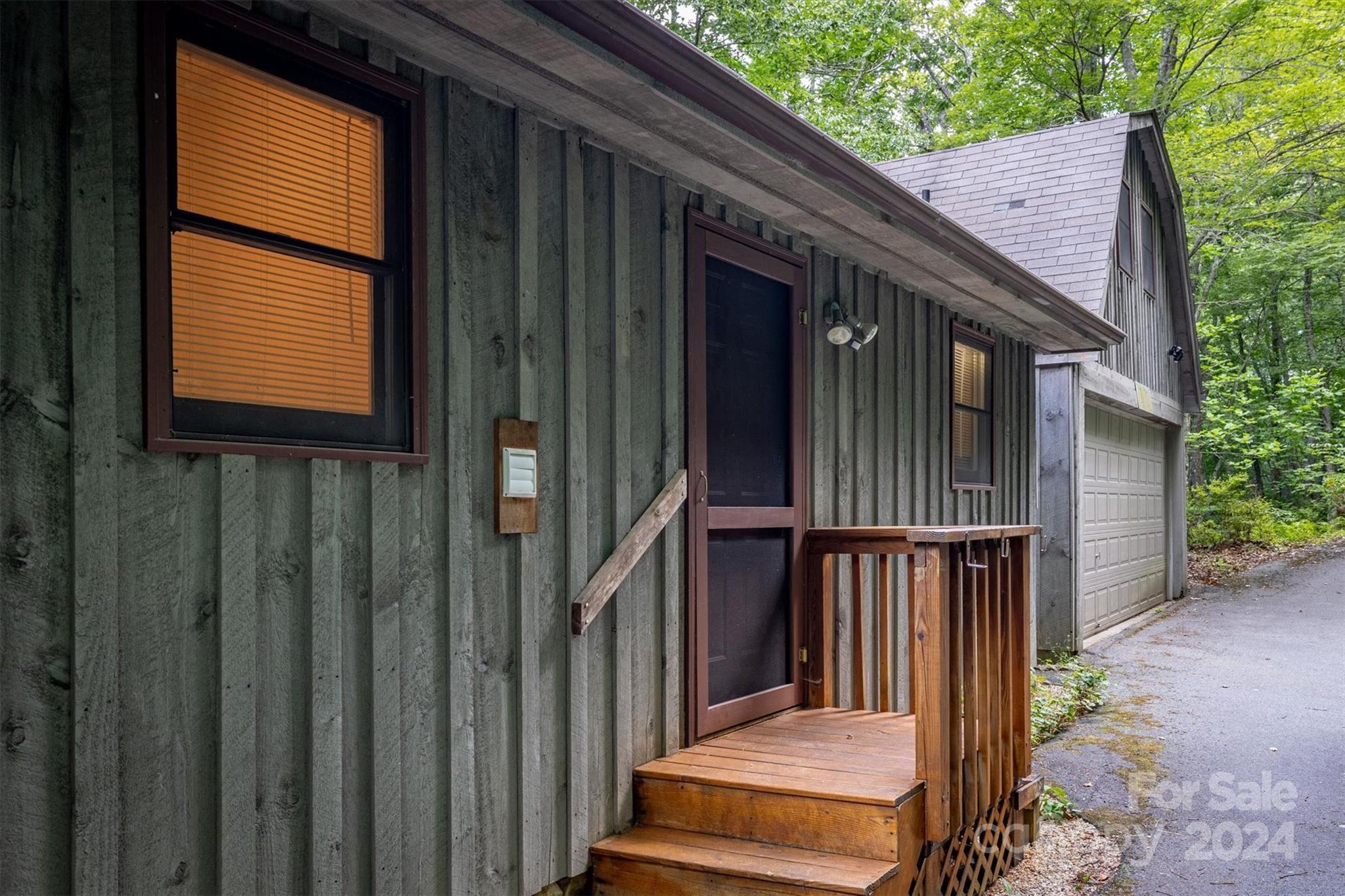 455 Hemlock Hill Road Boone, NC 28607 - Photo 4 of 37 a backyard of a house with wooden fence and deck