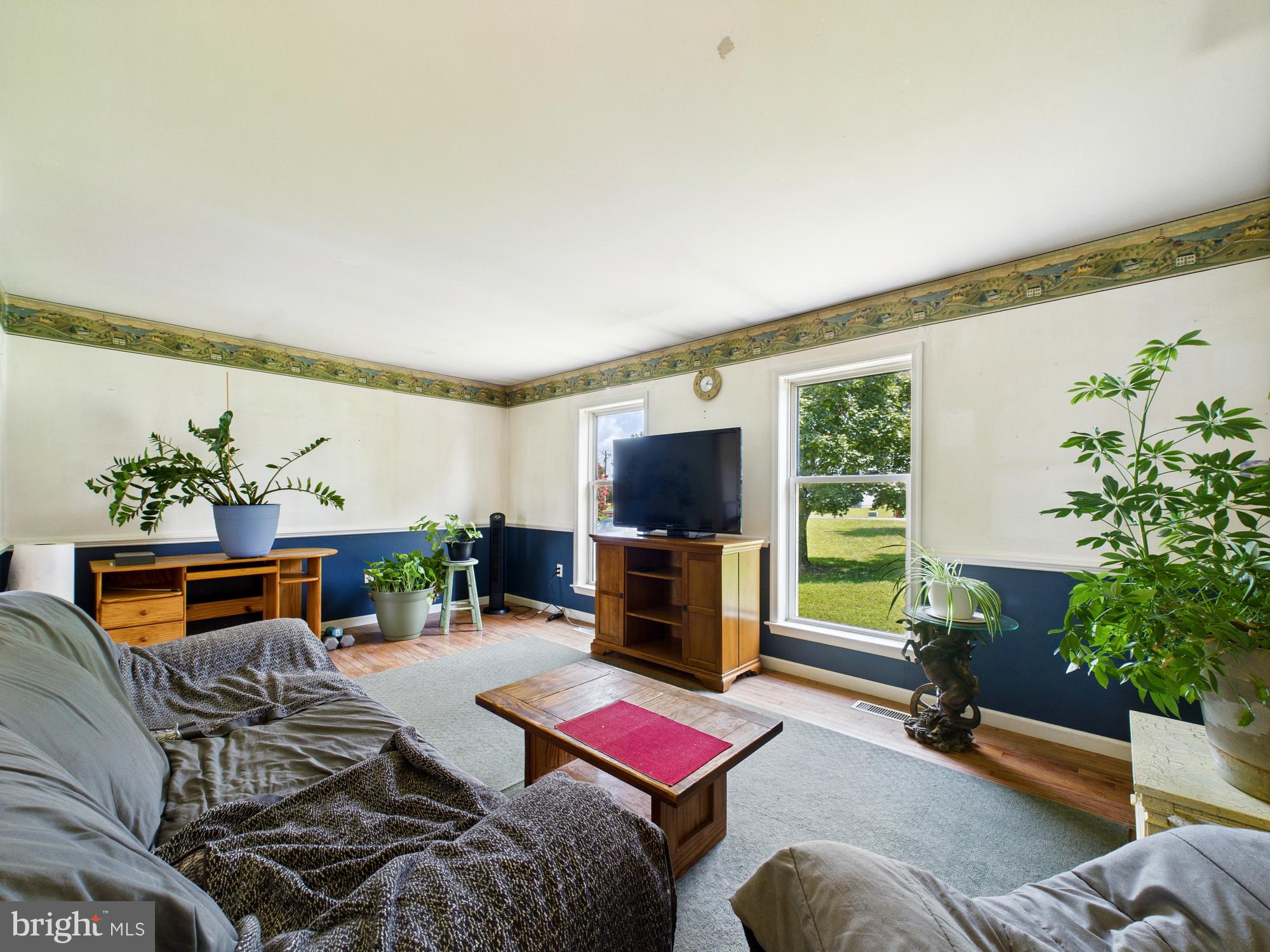 12502 Woodbridge Road Greenwood, DE 19950 - Photo 2 of 38 a living room with furniture and a flat screen tv
