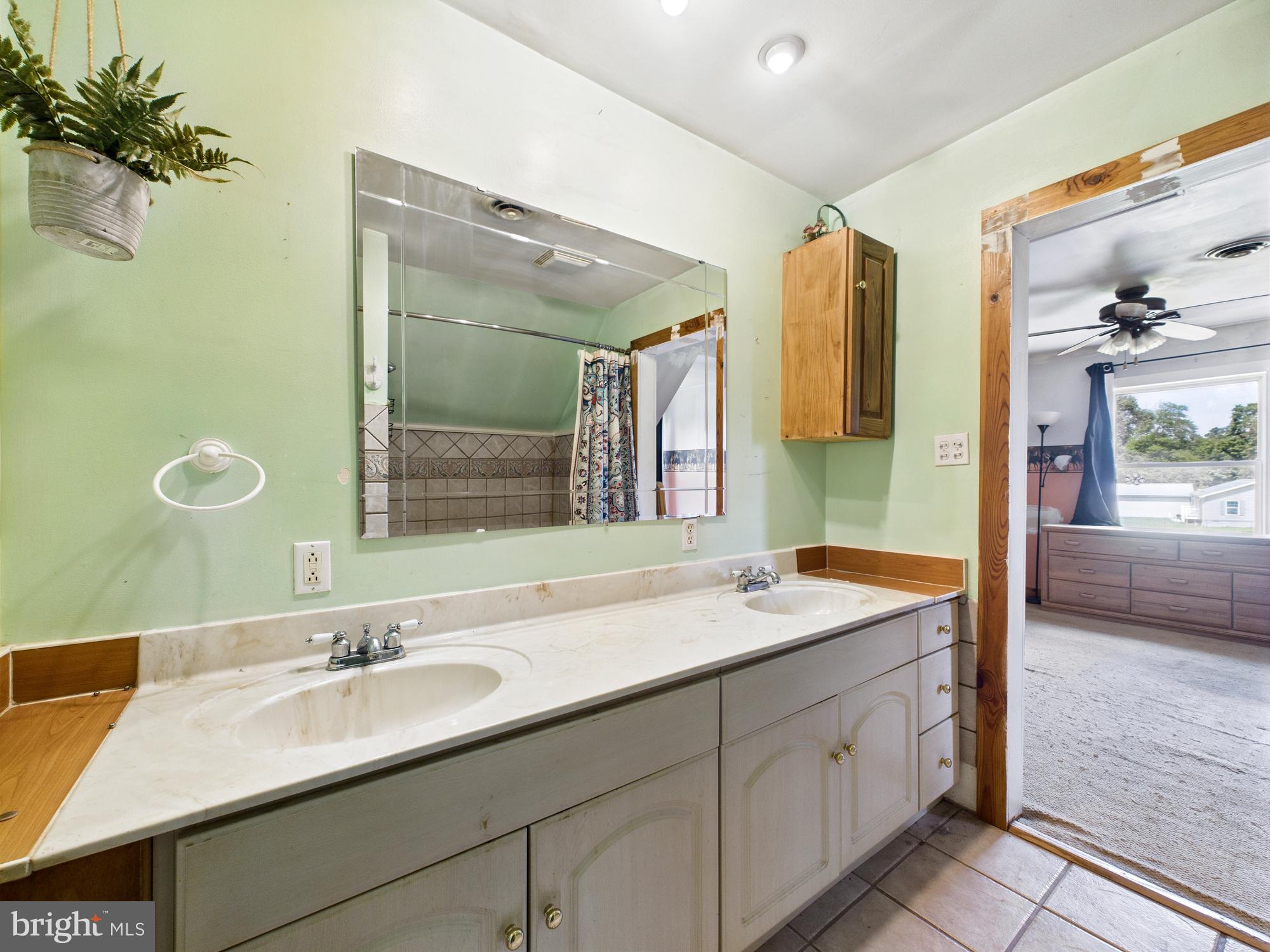 12502 Woodbridge Road Greenwood, DE 19950 - Photo 26 of 38 a bathroom with a granite countertop sink and a mirror
