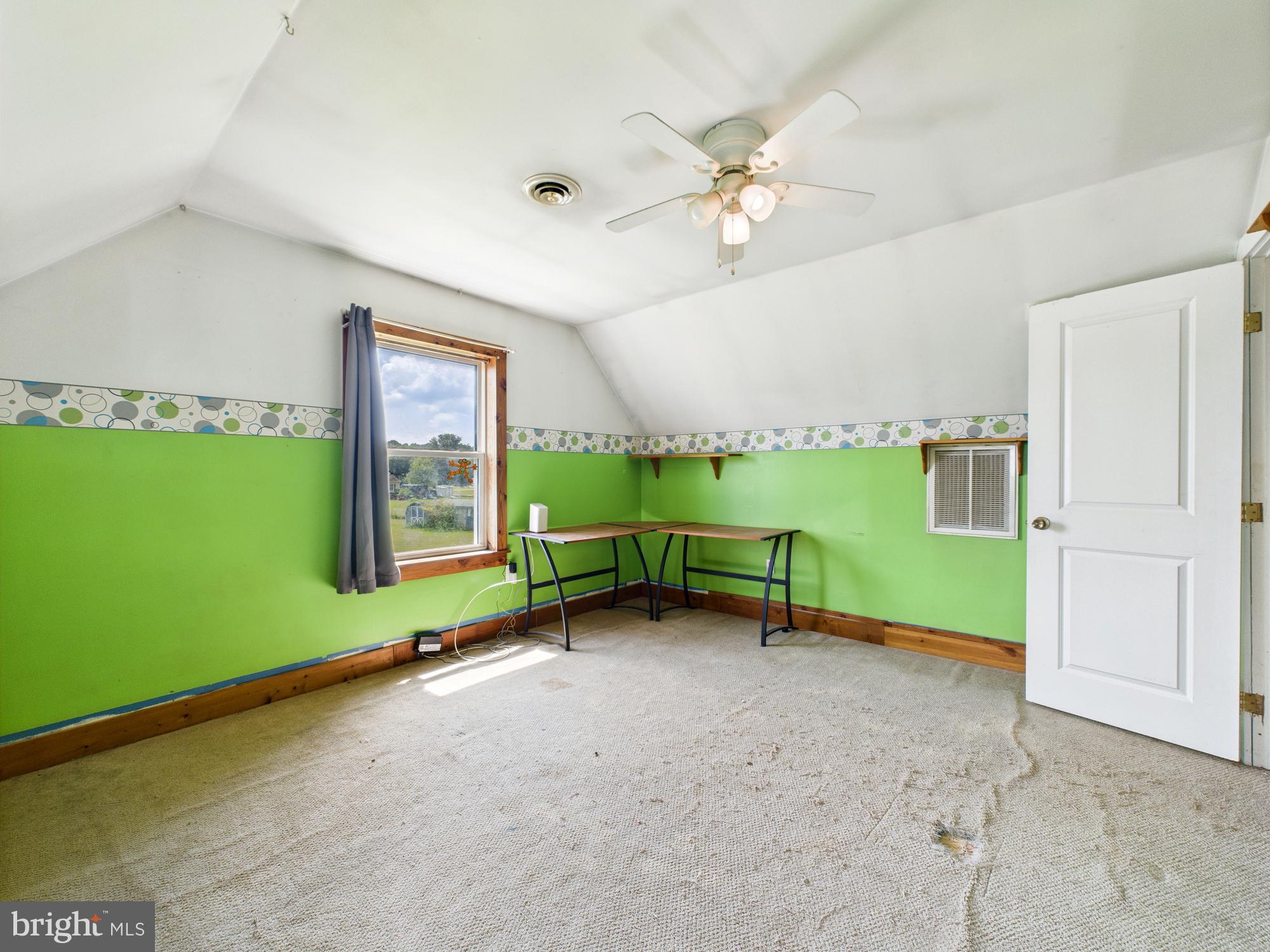 12502 Woodbridge Road Greenwood, DE 19950 - Photo 30 of 38 a view of an empty room with a window and a kitchen