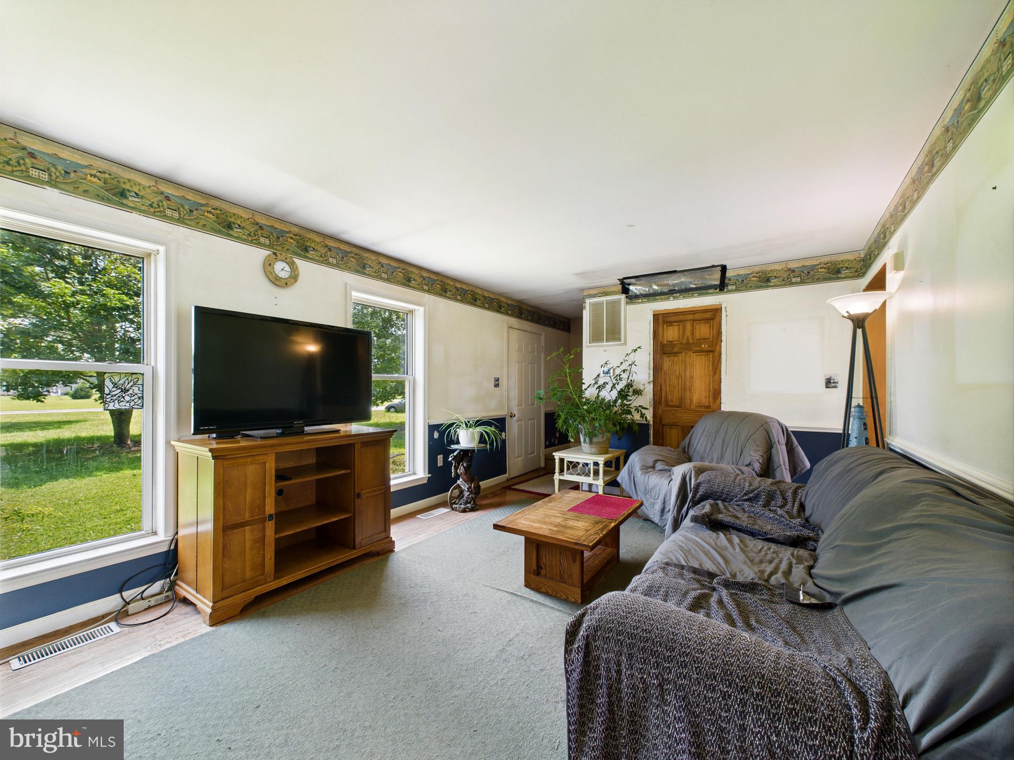 12502 Woodbridge Road Greenwood, DE 19950 - Photo 3 of 38 a living room with furniture and a flat screen tv