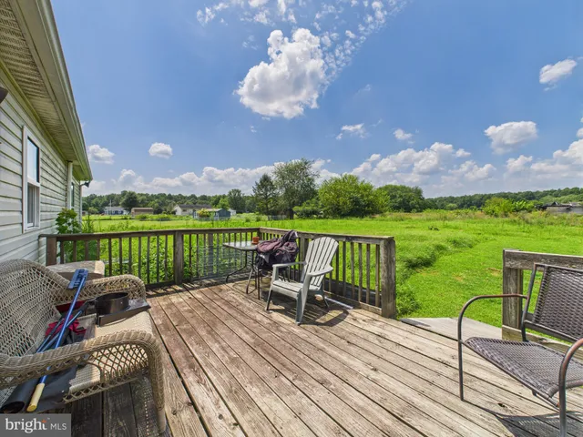 a view of deck with furniture and city view