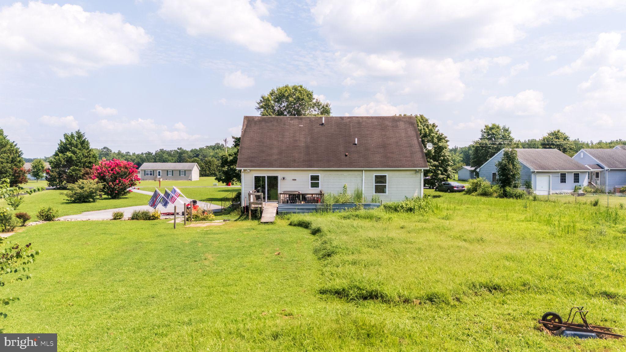 12502 Woodbridge Road Greenwood, DE 19950 - Photo 36 of 38 a view of a house with a garden and sitting area