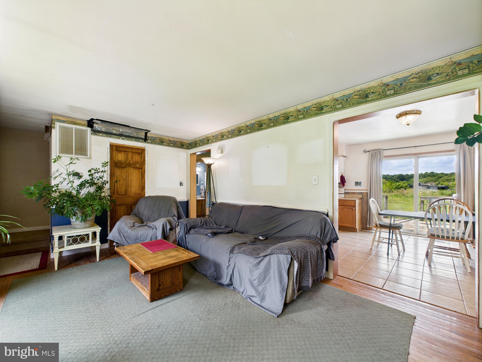 12502 Woodbridge Road Greenwood, DE 19950 - Photo 4 of 38 a living room with furniture and a large window