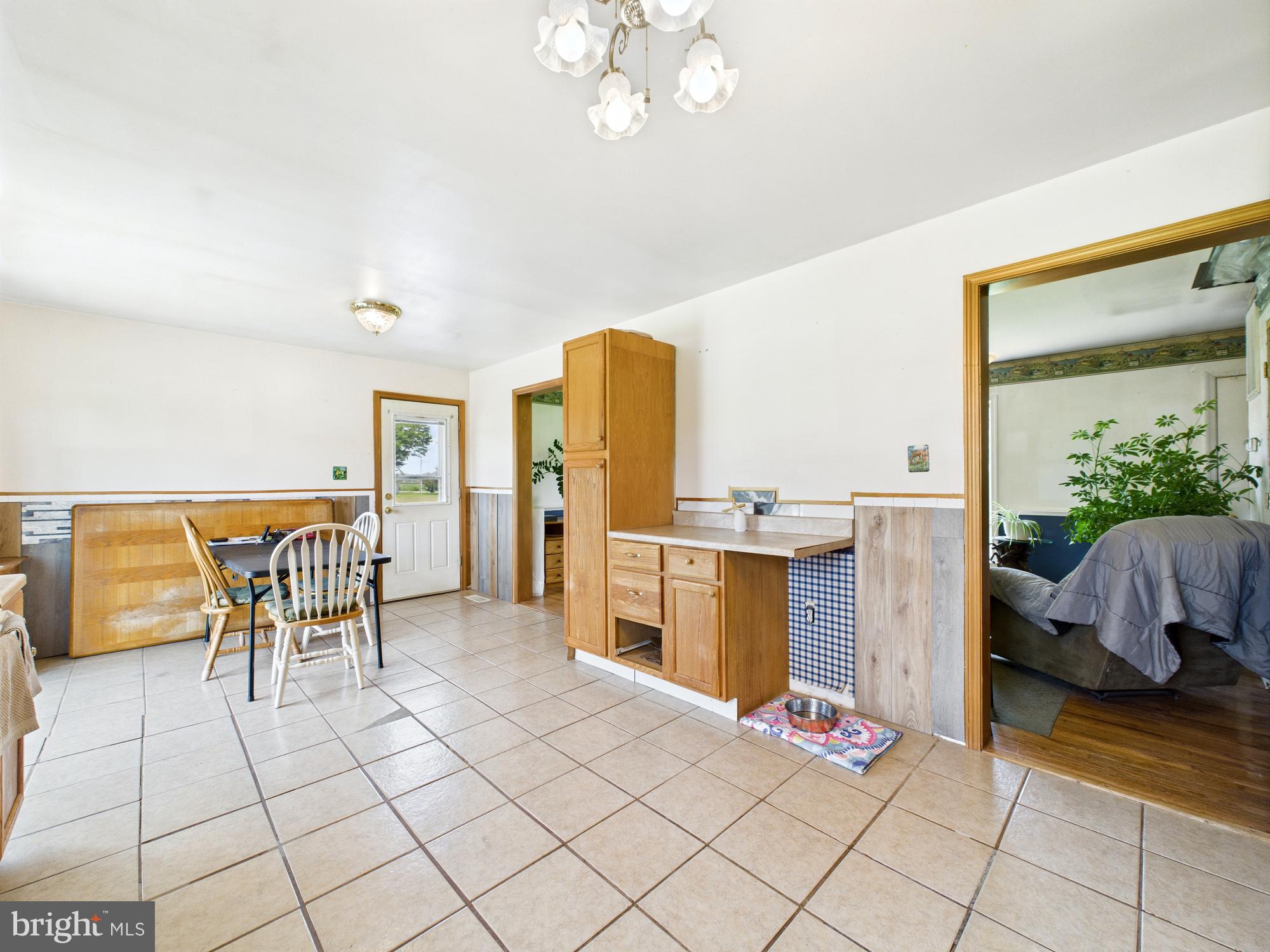 12502 Woodbridge Road Greenwood, DE 19950 - Photo 9 of 38 a dining room with furniture and a floor to ceiling window