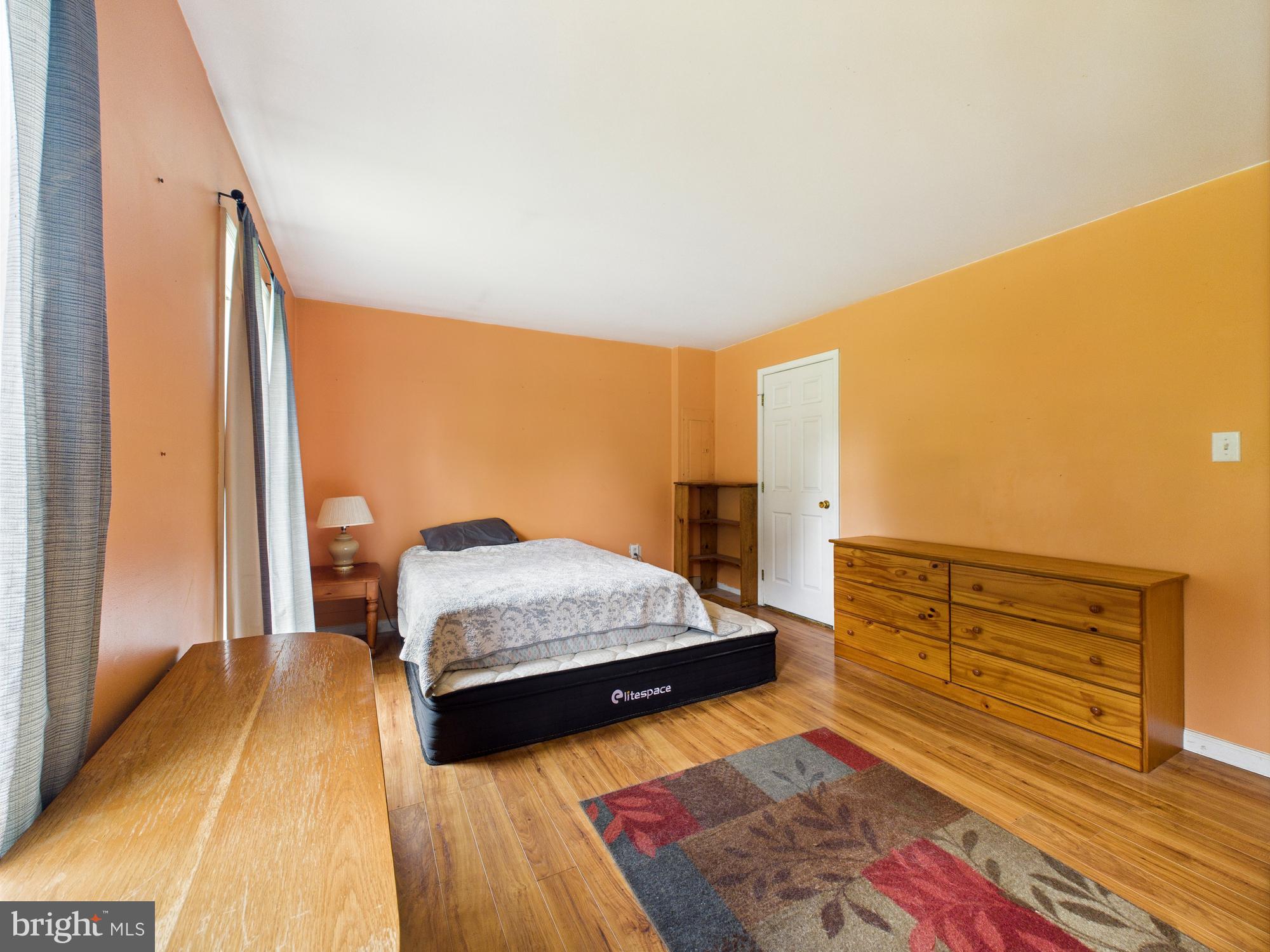 12502 Woodbridge Road Greenwood, DE 19950 - Photo 10 of 38 a bedroom with a bed and wooden floor