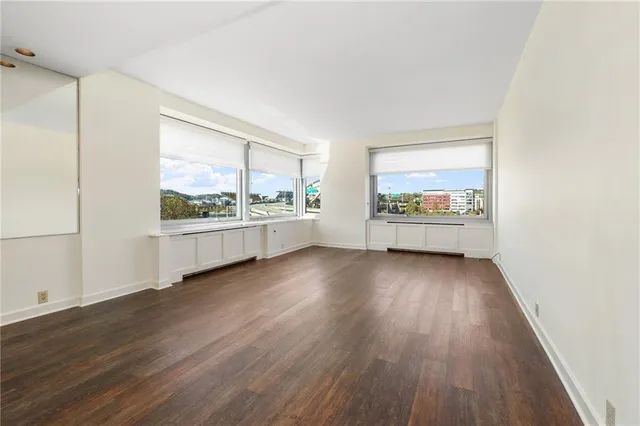 wooden floor in an empty room with a window
