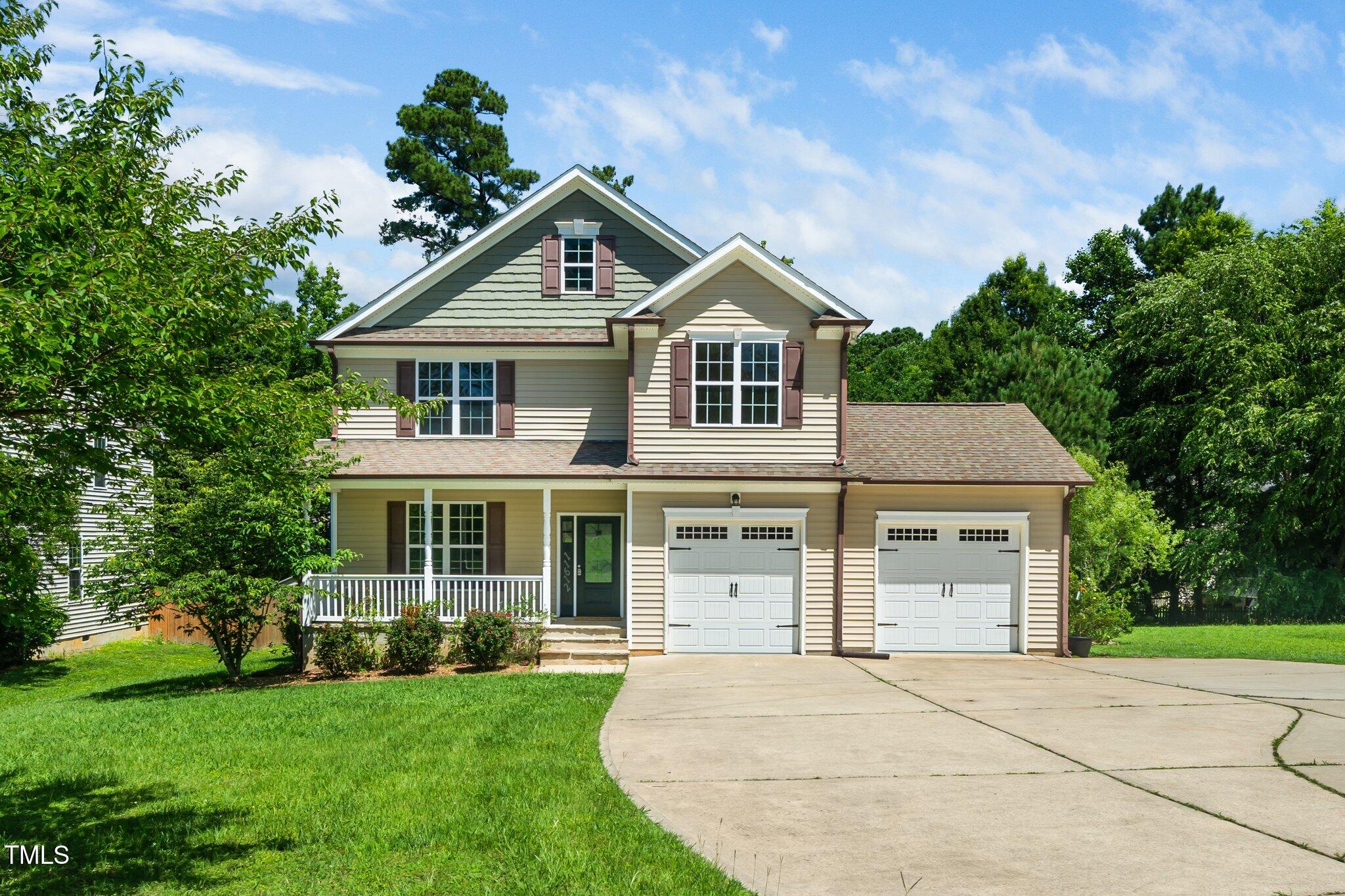 11612 Leesville Road Raleigh, NC 27613 - Photo 1 of 32 a front view of a house with a garden