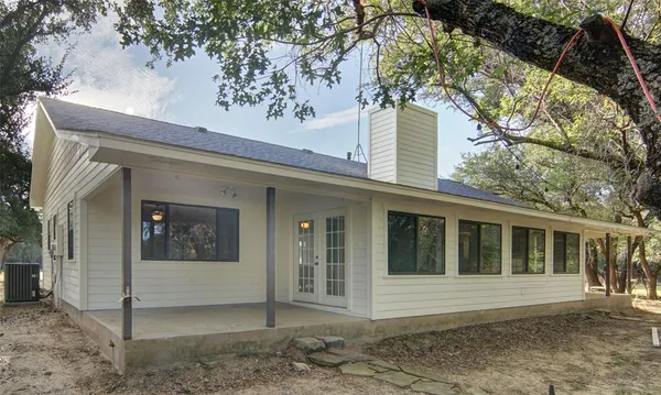 a view of a house with a tree