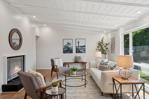 a living room with furniture a chandelier and a window