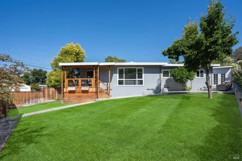 a view of a house with a yard porch and sitting area